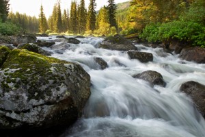 Sunrise and mountain flowing stream